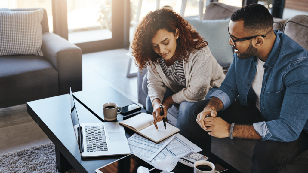South African consumers reviewing their financial documents to Improve Your Credit Score, showing a collaborative approach to managing debt and credit.